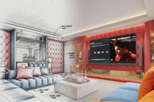 Luxury private karaoke lounge in a Maprachan Pattaya villa featuring red diamond-tufted accent wall, large blue velvet L-shaped sofa, white marble coffee table, and The Weeknd playing on the big screen.