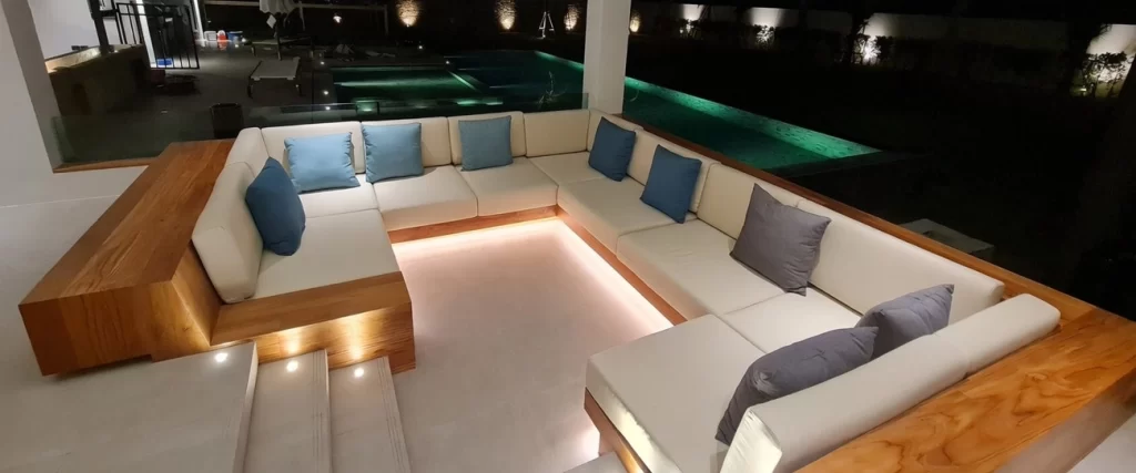 Luxurious sunken lounge with ambient lighting and infinity pool at night – Maprachan Pattaya